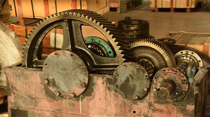 Close-up of a large gearbox of a motor being disassembled at repair and services facility